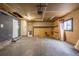 Unfinished garage featuring exposed brick, concrete floor, and room for projects and vehicle storage at 5542 Sable St, Denver, CO 80239