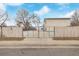 View of side gate with fenced property for privacy and security at 5542 Sable St, Denver, CO 80239