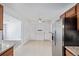 Open concept view from the kitchen featuring stainless appliances, wood cabinets, and granite countertops at 5542 Sable St, Denver, CO 80239