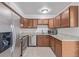 Kitchen features stainless steel appliances, granite countertops, and wood cabinets at 5542 Sable St, Denver, CO 80239