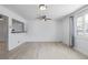 Bright living room featuring updated flooring, a ceiling fan, and large windows offering plenty of natural light at 5542 Sable St, Denver, CO 80239