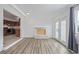 Bright living room featuring wood floors, a fireplace, and access to the backyard through glass doors at 5542 Sable St, Denver, CO 80239