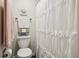 Comfortable bathroom featuring a toilet, decorative towels, and a shower with a stylish curtain at 7995 E Mississippi Ave # F23, Denver, CO 80247