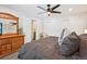 Spacious bedroom with plush carpeting, a ceiling fan, and an adjacent bathroom doorway at 7995 E Mississippi Ave # F23, Denver, CO 80247
