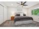 Comfortable bedroom featuring plush carpeting, a ceiling fan, and a tufted headboard on the well-lit bed at 7995 E Mississippi Ave # F23, Denver, CO 80247