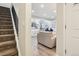 Open concept home with stairs and hardwood floors connecting the living room and kitchen at 7995 E Mississippi Ave # F23, Denver, CO 80247