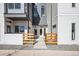 Contemporary townhome entrances with modern fencing and well-maintained landscaping at 5371 W 14Th Ave, Lakewood, CO 80214