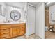 Bathroom with a wooden vanity, decorative mirror, and a tiled shower at 14226 E 1St Dr # B10, Aurora, CO 80011