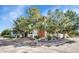Exterior corner view showcasing mature trees and the side of this multi-unit condo at 14226 E 1St Dr # B10, Aurora, CO 80011