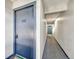 Hallway view featuring apartment door with unit number and gray carpeting at 14226 E 1St Dr # B10, Aurora, CO 80011