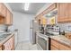 Bright kitchen with stainless steel appliances, tile flooring, and light wood cabinets at 14226 E 1St Dr # B10, Aurora, CO 80011