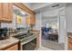 Well-equipped kitchen open to the living room with stainless steel appliances and countertops at 14226 E 1St Dr # B10, Aurora, CO 80011