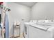 Laundry room with a washer, dryer, and storage shelves for convenience at 14226 E 1St Dr # B10, Aurora, CO 80011