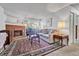 Cozy living room with a brick fireplace, comfortable seating and a large rug at 14226 E 1St Dr # B10, Aurora, CO 80011