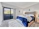 Main bedroom with a sliding glass door, plush carpeting, and a tufted headboard at 14226 E 1St Dr # B10, Aurora, CO 80011