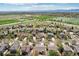 Neighborhood aerial view showcasing green spaces, houses, and mountain views in the distance at 4553 Red Deer Trl, Broomfield, CO 80020