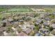 Aerial view of a residential neighborhood with green spaces, lawns, sidewalks, mature trees and mountains in the distance at 4553 Red Deer Trl, Broomfield, CO 80020