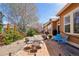 Cozy backyard featuring brick patio, mature trees, rock garden and comfortable seating for outdoor entertaining at 4553 Red Deer Trl, Broomfield, CO 80020