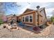 A backyard with a stone patio and walkway, rock garden, mature landscaping, grill and outdoor seating at 4553 Red Deer Trl, Broomfield, CO 80020