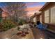 Inviting backyard patio with outdoor seating, potted flowers, and serene ambiance at sunset at 4553 Red Deer Trl, Broomfield, CO 80020