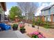 Charming backyard with a brick patio, table set, and colorful flower pots at 4553 Red Deer Trl, Broomfield, CO 80020