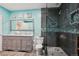 Contemporary bathroom featuring a double sink vanity, a glass-enclosed shower, and modern fixtures and a decorative mirror at 4553 Red Deer Trl, Broomfield, CO 80020