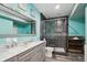 Modern bathroom with a double vanity, a glass-enclosed shower with custom tile work, and stylish fixtures and a decorative mirror at 4553 Red Deer Trl, Broomfield, CO 80020