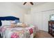 Bright bedroom featuring carpeted floors, a ceiling fan, and an adjacent closet with sliding doors at 4553 Red Deer Trl, Broomfield, CO 80020