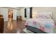Bedroom boasts wood floors, bright natural light, and a colorful patchwork quilt on the bed at 4553 Red Deer Trl, Broomfield, CO 80020