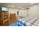 Spacious bedroom with wood floors, TV, and a stylish sliding barn door to the closet at 4553 Red Deer Trl, Broomfield, CO 80020
