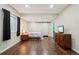 Cozy bedroom features a modern barn door, wood floors, and neutral color scheme at 4553 Red Deer Trl, Broomfield, CO 80020