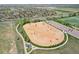 Aerial view of dog park featuring a spacious, fenced area with a shelter and walking path at 4553 Red Deer Trl, Broomfield, CO 80020