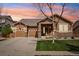 Charming home with a manicured lawn, stone accents, a covered porch, and a two-car garage at 4553 Red Deer Trl, Broomfield, CO 80020