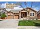 Inviting single-Gathering home showcasing two garage doors, stone accents, a well-manicured lawn, and seller concessions! at 4553 Red Deer Trl, Broomfield, CO 80020
