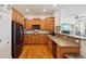 Modern kitchen with wood cabinets, stainless appliances, and a view to the spacious living area at 4553 Red Deer Trl, Broomfield, CO 80020