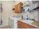 Functional laundry room with washer, dryer, utility sink, and ample storage space at 4553 Red Deer Trl, Broomfield, CO 80020