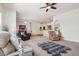 Open-concept living room with a ceiling fan, large seating, neutral decor and views to kitchen at 4553 Red Deer Trl, Broomfield, CO 80020