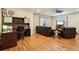 Inviting living space with hardwood floors, a cozy sitting area, and a functional office setup with built-in shelving at 4553 Red Deer Trl, Broomfield, CO 80020