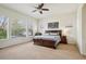Light-filled primary bedroom featuring an elegant wood bed frame and large windows at 4553 Red Deer Trl, Broomfield, CO 80020