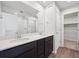 Well lit bathroom featuring dual sinks, modern fixtures, and a glass shower at 19059 E 94Th Pl, Commerce City, CO 80022