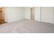 Spacious bedroom with neutral carpet, white walls, and entry to the closet at 19059 E 94Th Pl, Commerce City, CO 80022