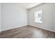 Bright bedroom features wood-look floors and a sunlit window at 19059 E 94Th Pl, Commerce City, CO 80022
