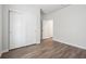 Bedroom features closet with sliding doors and wood-look flooring at 19059 E 94Th Pl, Commerce City, CO 80022
