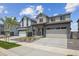 Exterior view of this two-story home featuring a two-car garage and manicured landscaping at 19059 E 94Th Pl, Commerce City, CO 80022