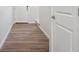 Hallway with hardwood-style flooring and a white door leading to other areas of the home at 19059 E 94Th Pl, Commerce City, CO 80022