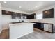 Beautiful kitchen with dark cabinets, stainless steel appliances, island and ample counter space at 19059 E 94Th Pl, Commerce City, CO 80022