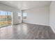 Bright living room with sliding glass doors offering backyard views and modern flooring at 19059 E 94Th Pl, Commerce City, CO 80022
