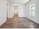Spacious living room with wood-look flooring, large windows, and a bright and airy atmosphere at 19059 E 94Th Pl, Commerce City, CO 80022
