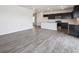 Open floor plan showcasing the living area connected to the modern kitchen with island at 19059 E 94Th Pl, Commerce City, CO 80022