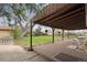 Inviting backyard deck features seating and serene views of the lush, landscaped yard at 865 S Everett St, Lakewood, CO 80226